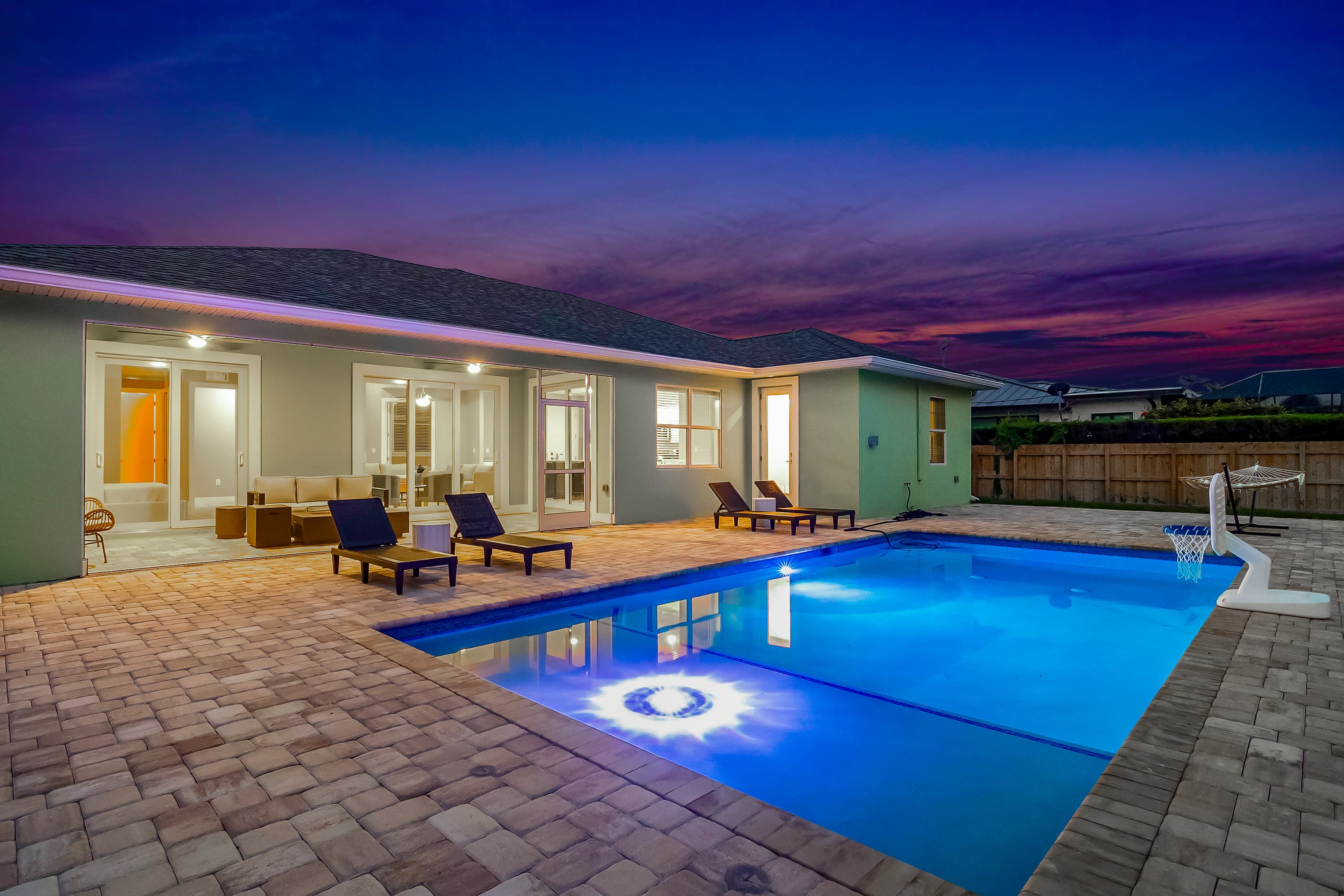 Pool and patio with hammock at dusk